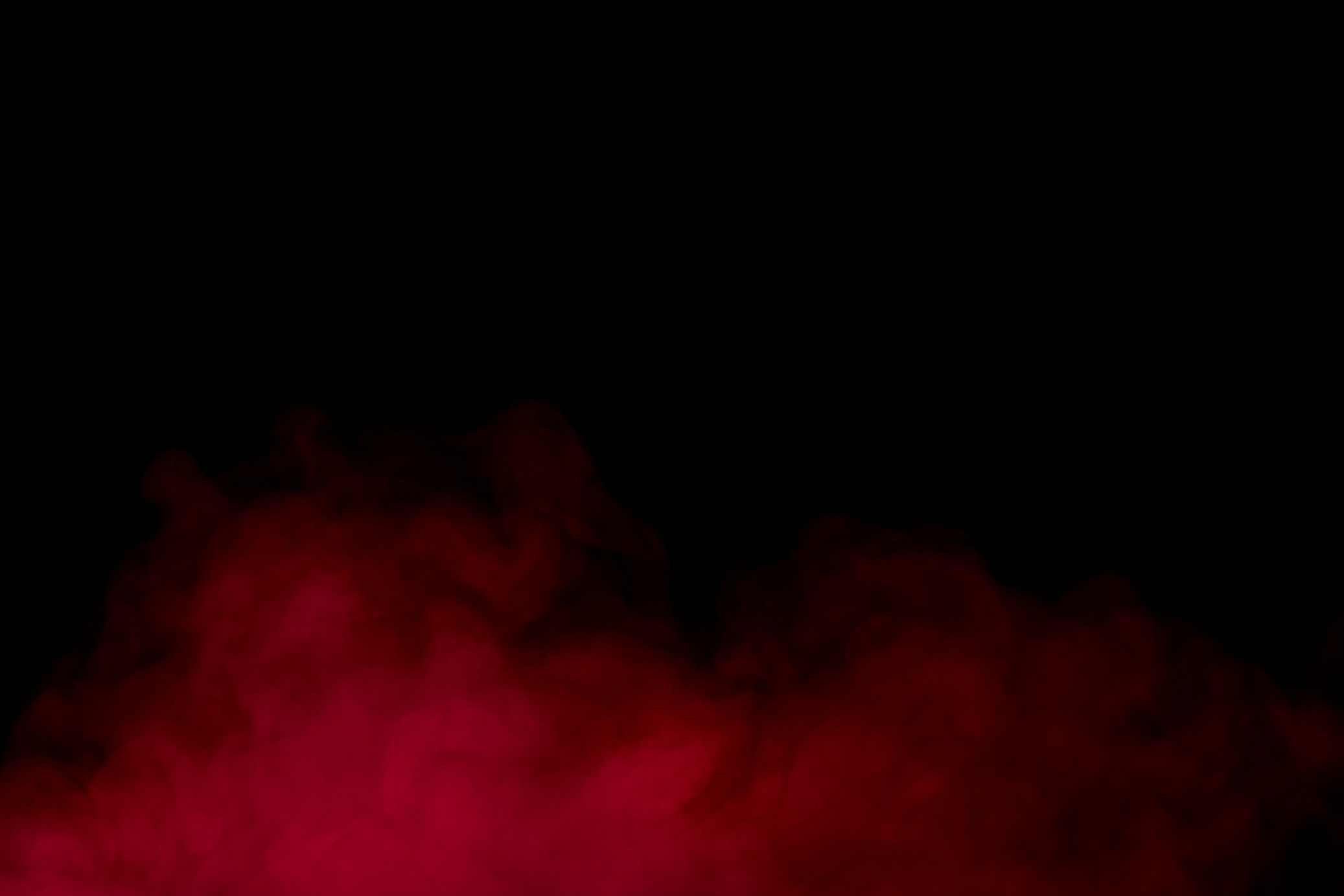 red smoke on a dark background concept of smoking